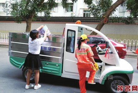 市民自觉将垃圾倒入垃圾车。 本报记者周燕红摄<br>